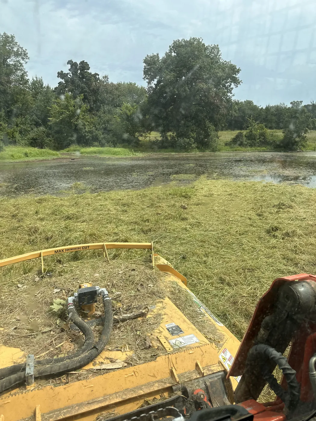 Stock pond holding water at the edge of a worked field
